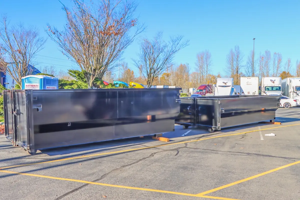Professional dumpster rental service with roll-off container on residential driveway in South Bend